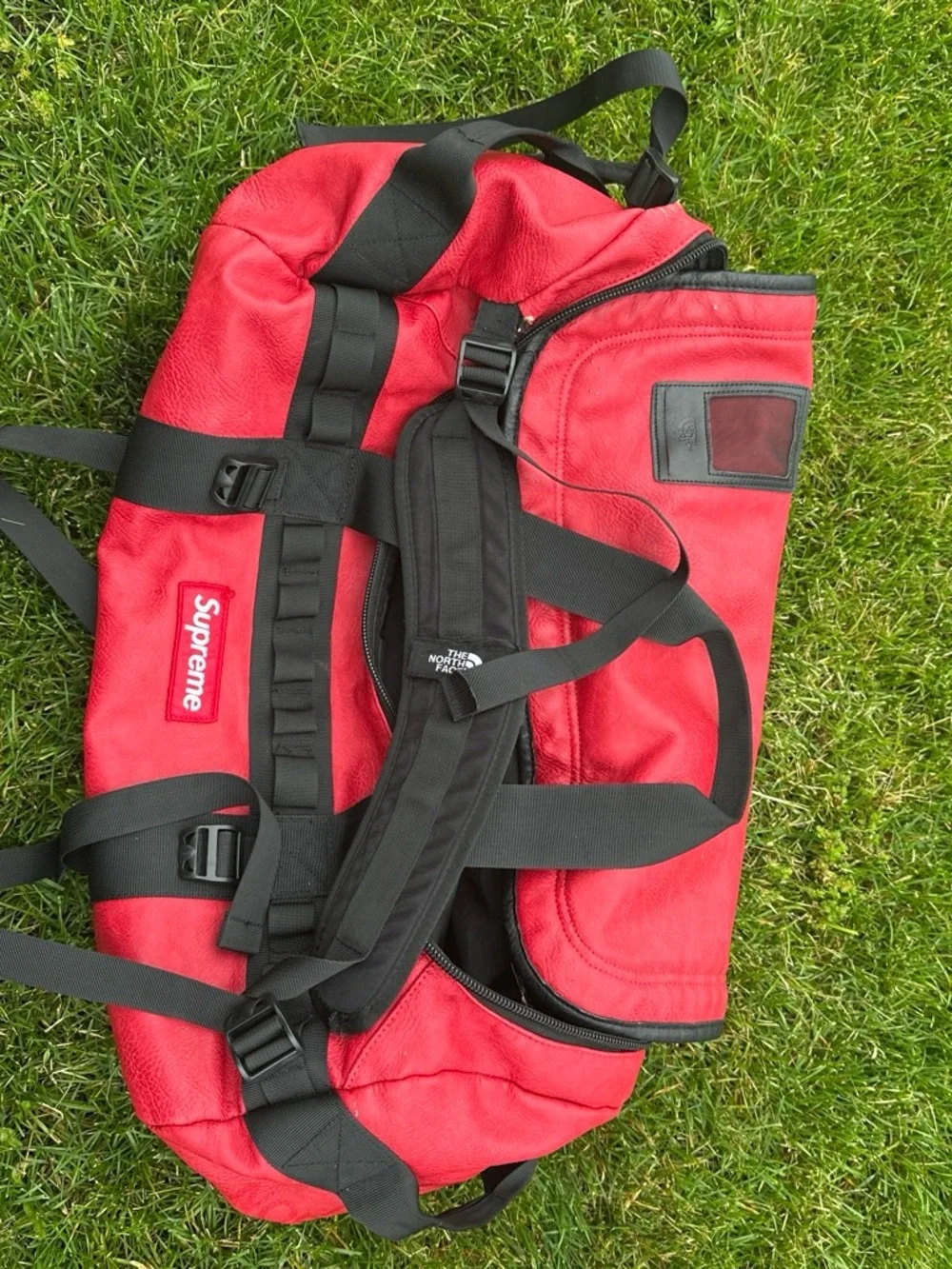 The North Face x Supreme Red Duffel Bag with Black Straps